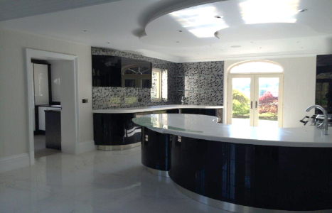 Spacious Black and White Kitchen with curved island.